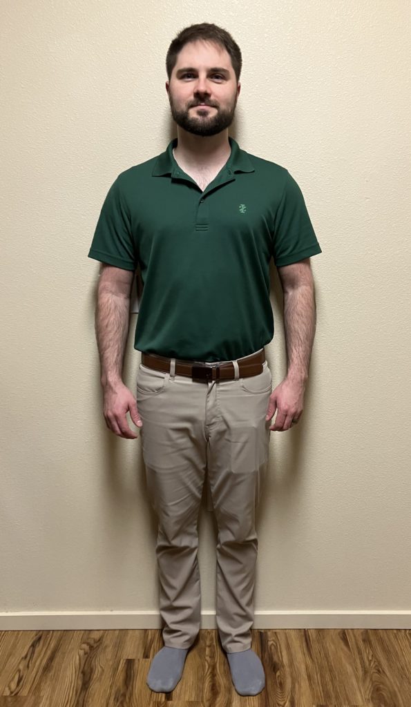 Standing facing the camera, Chin level, neck upright, chest open, shoulders back, no rotation in the knees, weight balanced evenly