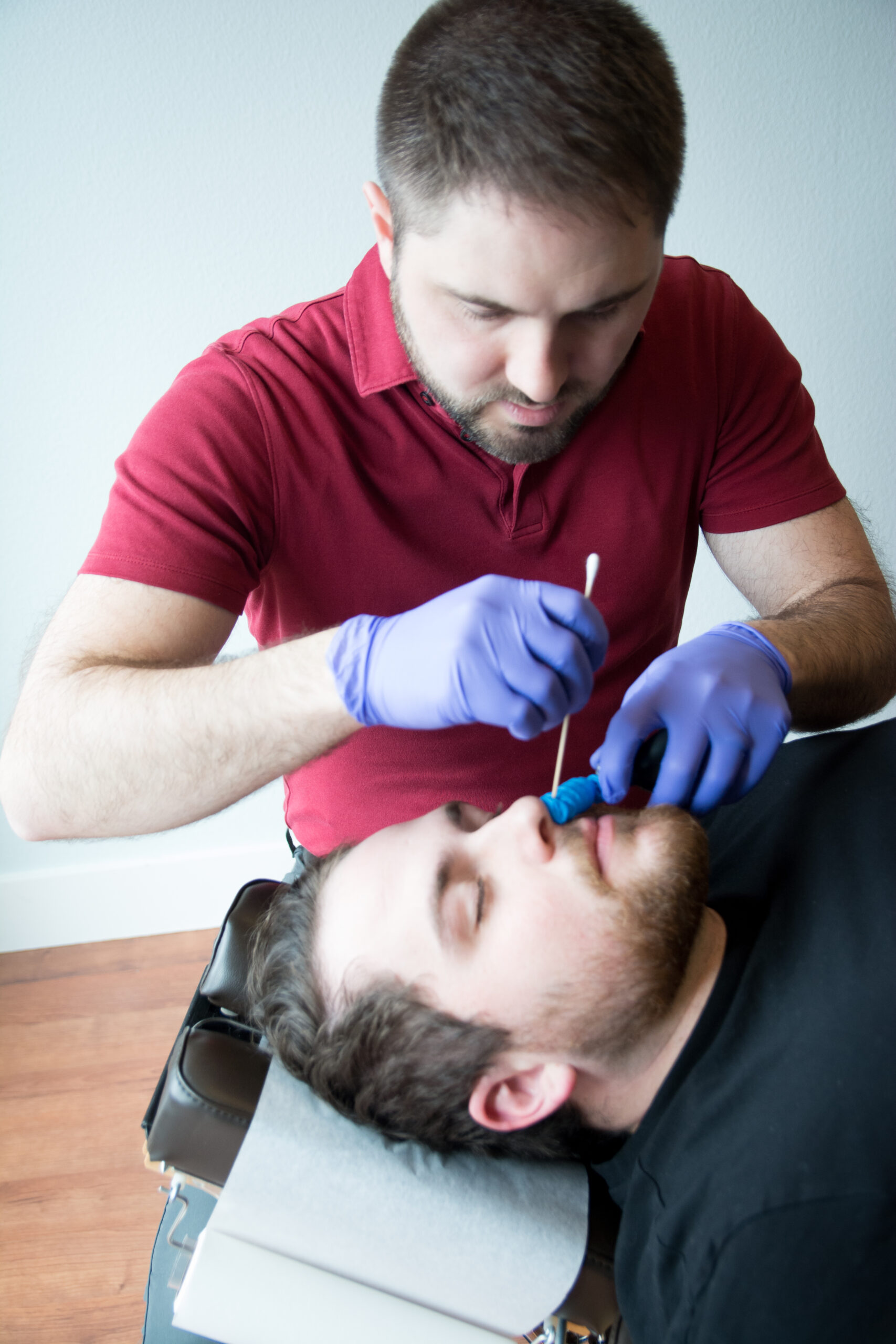 Dr. Mason Stewart, DC of New Leaf House Call Chiropractic in Post Falls, ID conducts the Nasal Specific Technique on a male patient.