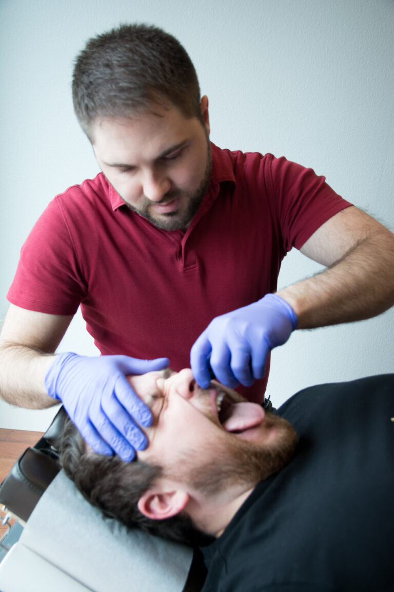 Dr. Mason Stewart, DC of New Leaf House Call Chiropractic in Post Falls, ID conducts the Nasal Specific Technique on a male patient.